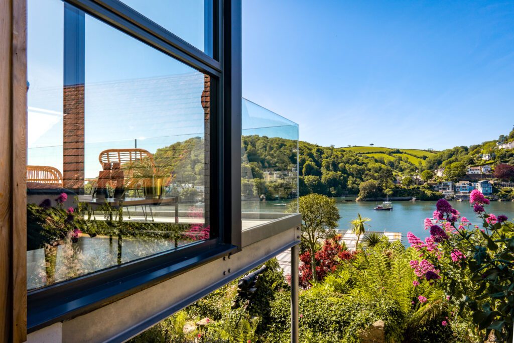 Glass-fronted gem in Kingswear, blending mid-century charm with stunning river and sea views in Kingswear. Sue Vaughton Photography