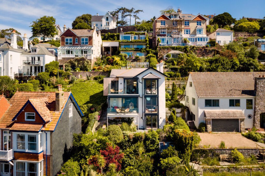 A glass-fronted gem in Kingswear, blending mid-century charm with stunning river and sea views. Architectural Interior Photography by Sue Vaughton