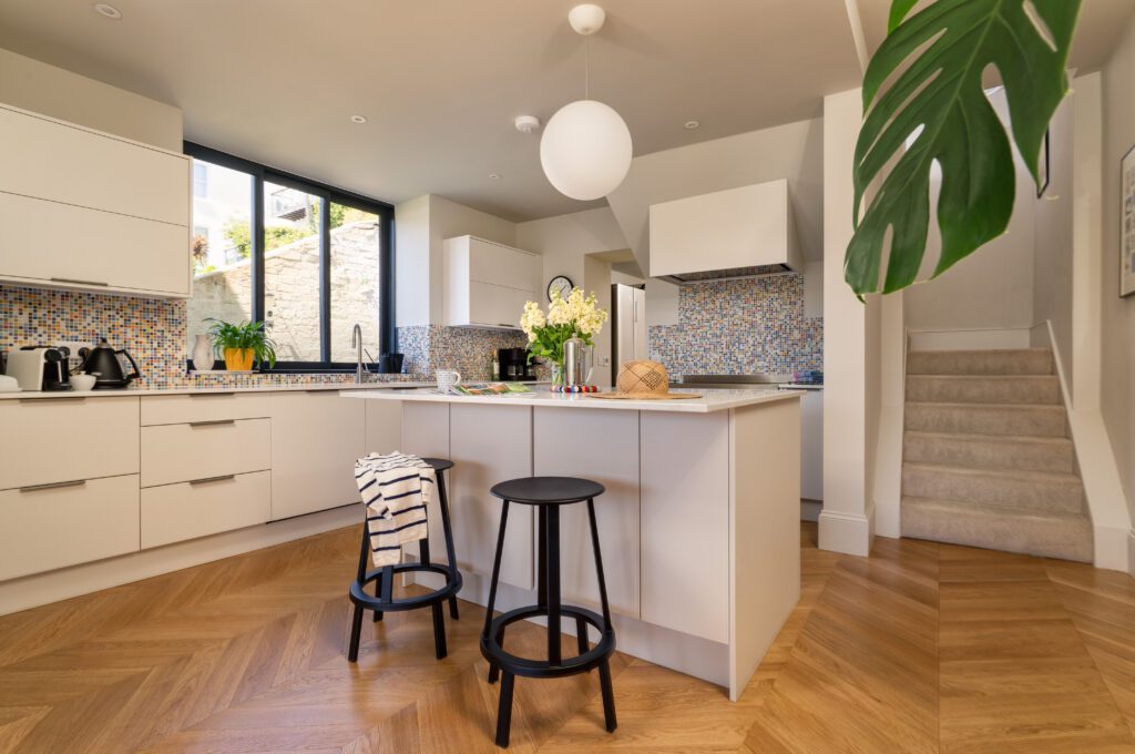 A glass-fronted gem in Kingswear, blending mid-century charm with stunning river and sea views. Architectural Interior Photography by Sue Vaughton