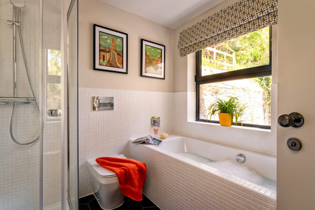 A glass-fronted gem in Kingswear, blending mid-century charm with stunning river and sea views. Architectural Interior Photography by Sue Vaughton