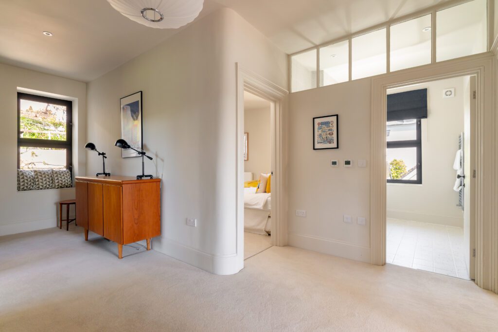 A glass-fronted gem in Kingswear, blending mid-century charm with stunning river and sea views. Architectural Interior Photography by Sue Vaughton