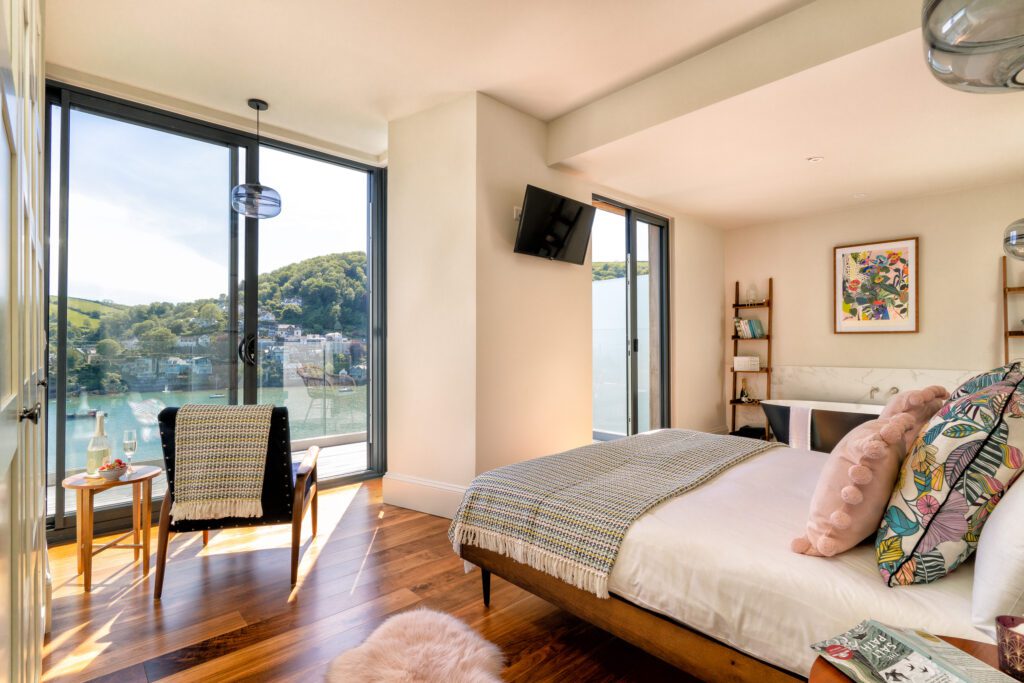 A glass-fronted gem in Kingswear, blending mid-century charm with stunning river and sea views. Architectural Interior Photography by Sue Vaughton