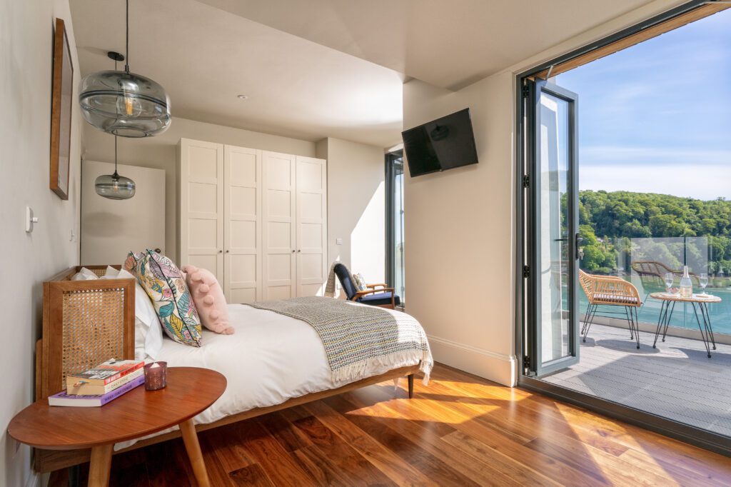 A glass-fronted gem in Kingswear, blending mid-century charm with stunning river and sea views. Architectural Interior Photography by Sue Vaughton