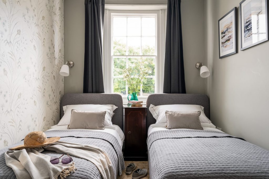 Charming Totnes cottage bedroom with traditional furnishings and natural light. Photography by Sue Vaughton.