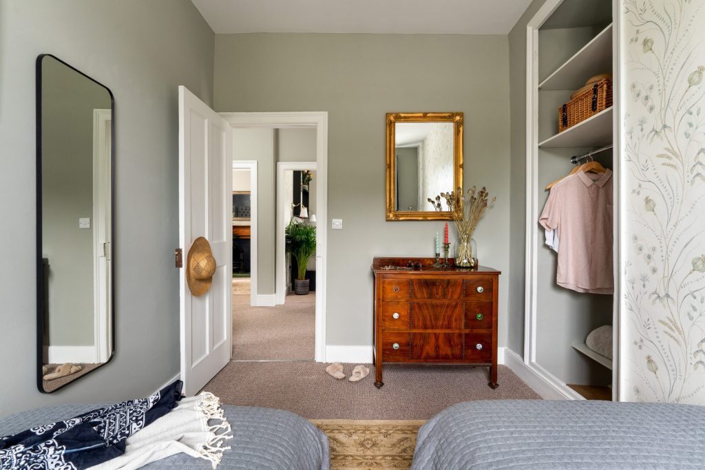 Charming Totnes cottage bedroom with traditional furnishings and natural light. Photography by Sue Vaughton.