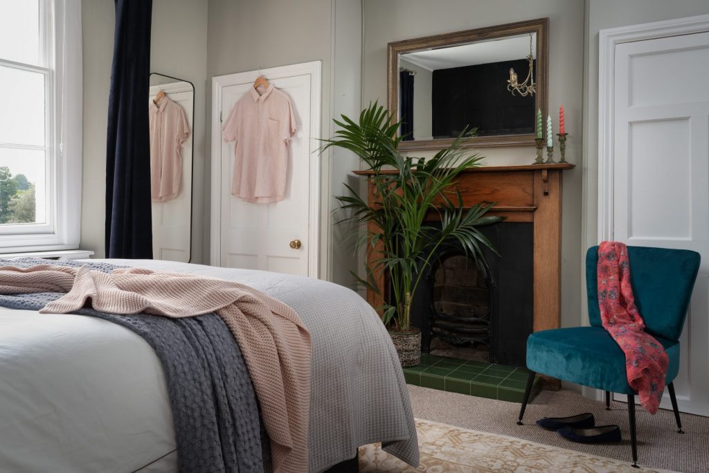 Elegant bedroom at St Maur Cottage in Totnes with Victorian sash windows and soft textiles. Interior photography by Sue Vaughton.