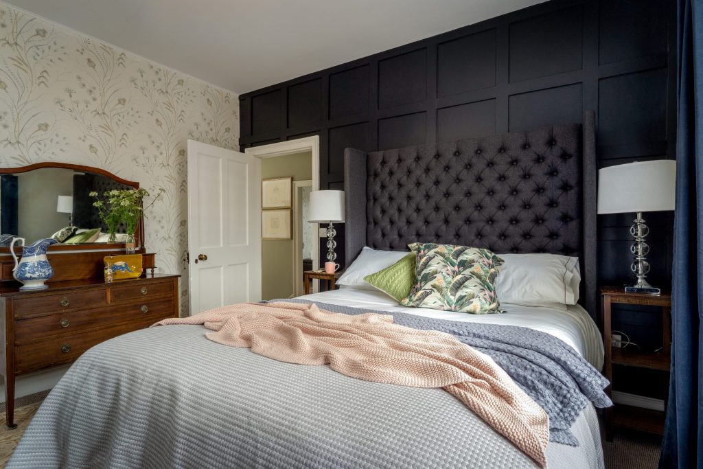 Elegant bedroom at St Maur Cottage in Totnes with Victorian sash windows and soft textiles. Interior photography by Sue Vaughton.