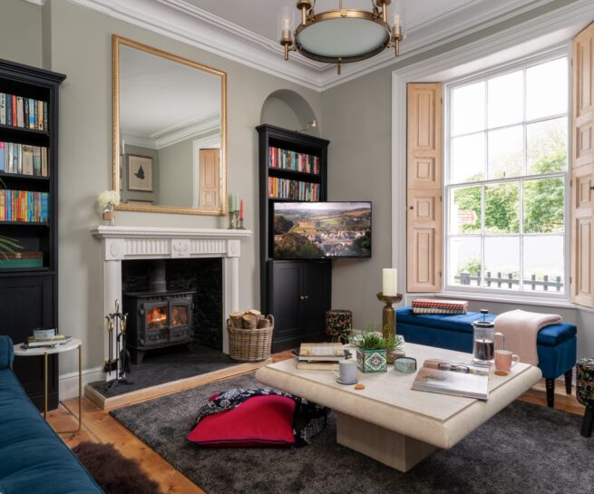 St Maur Cottage Totnes – Georgian living room with heritage details, wood burning stove, and acres of books. Photography by Sue Vaughton.