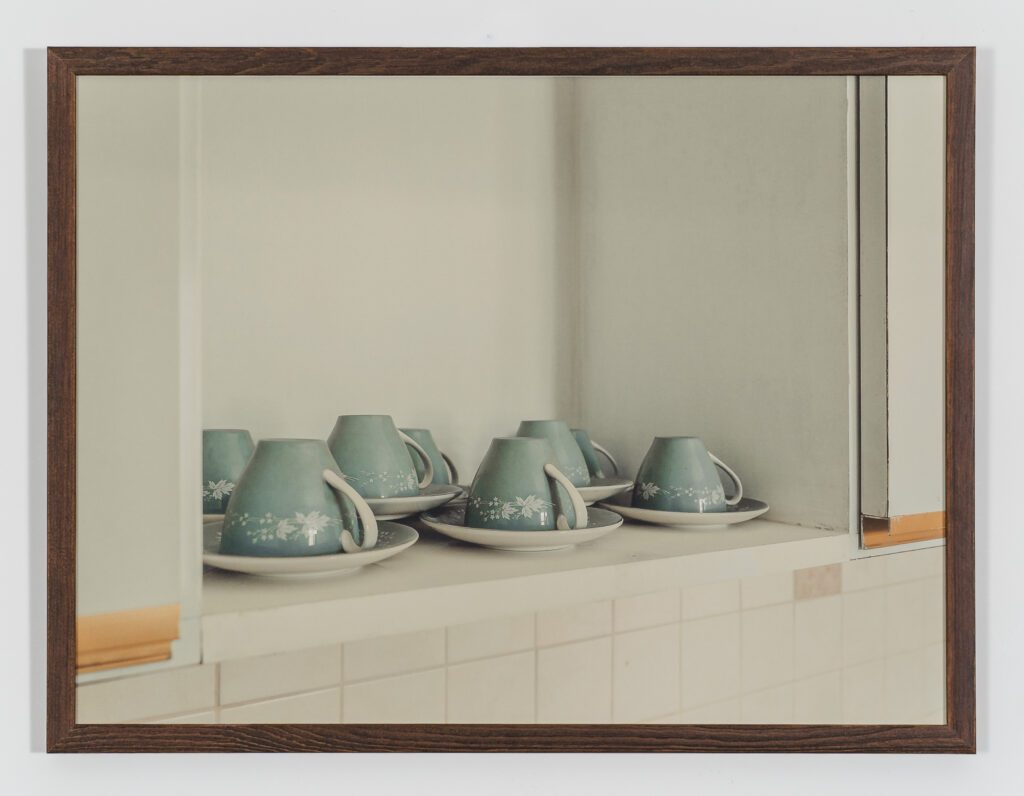 Teacups with saucers displayed on a shelf